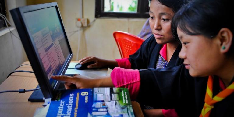 Students learn computer skills at a community e-center in Bhutan. Photo credit: ADB.