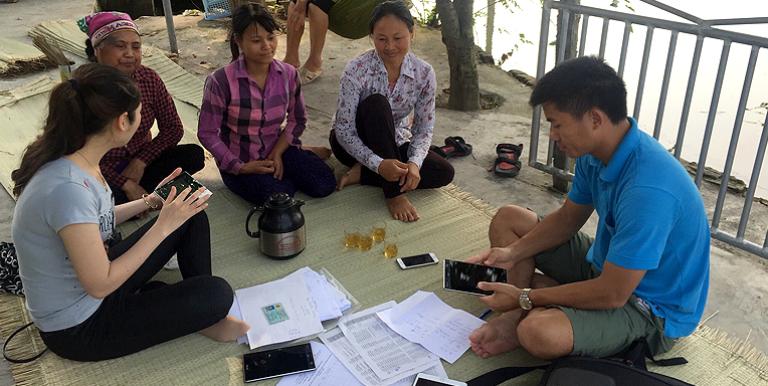 Staff from the Ministry of Agricultural and Rural Development in Viet Nam conduct a survey among farmers using smartphones. Photo credit: ADB.