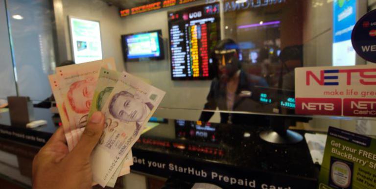 A money changer services customers at Changi Airport. Photo credit:  Lester Ledesma/ADB.
