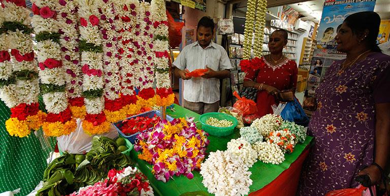 A roadside flower vendor does business at Singapore's Little India district. Traditional occupations like these remain part of daily life in Singapore.  Photo credit: ADB