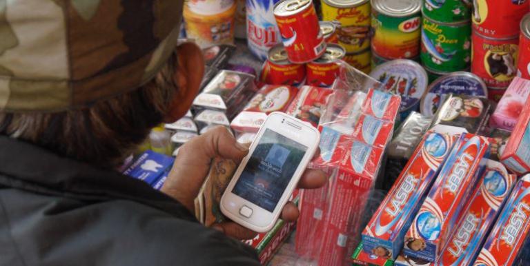 A merchant uses a smartphone to send money abroad. With mobile remittance solutions, many South Asians, particularly those from the rural areas, will be able to gain access to formal financial channels. Photo credit: Lester Ledesma/ADB.