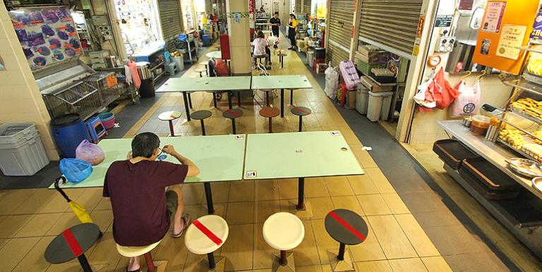 A food court marks seats to be left empty to ensure safe distancing between customers. Photo credit: ADB.