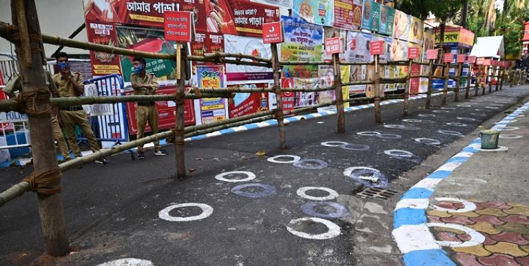 White circles were drawn on a road in India to enforce social distancing. Photo credit: iStock/Abhishek Kumar Sah.